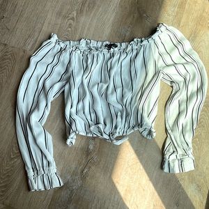 This is a off the shoulder crop top. It has an adjustable strap on the bottom